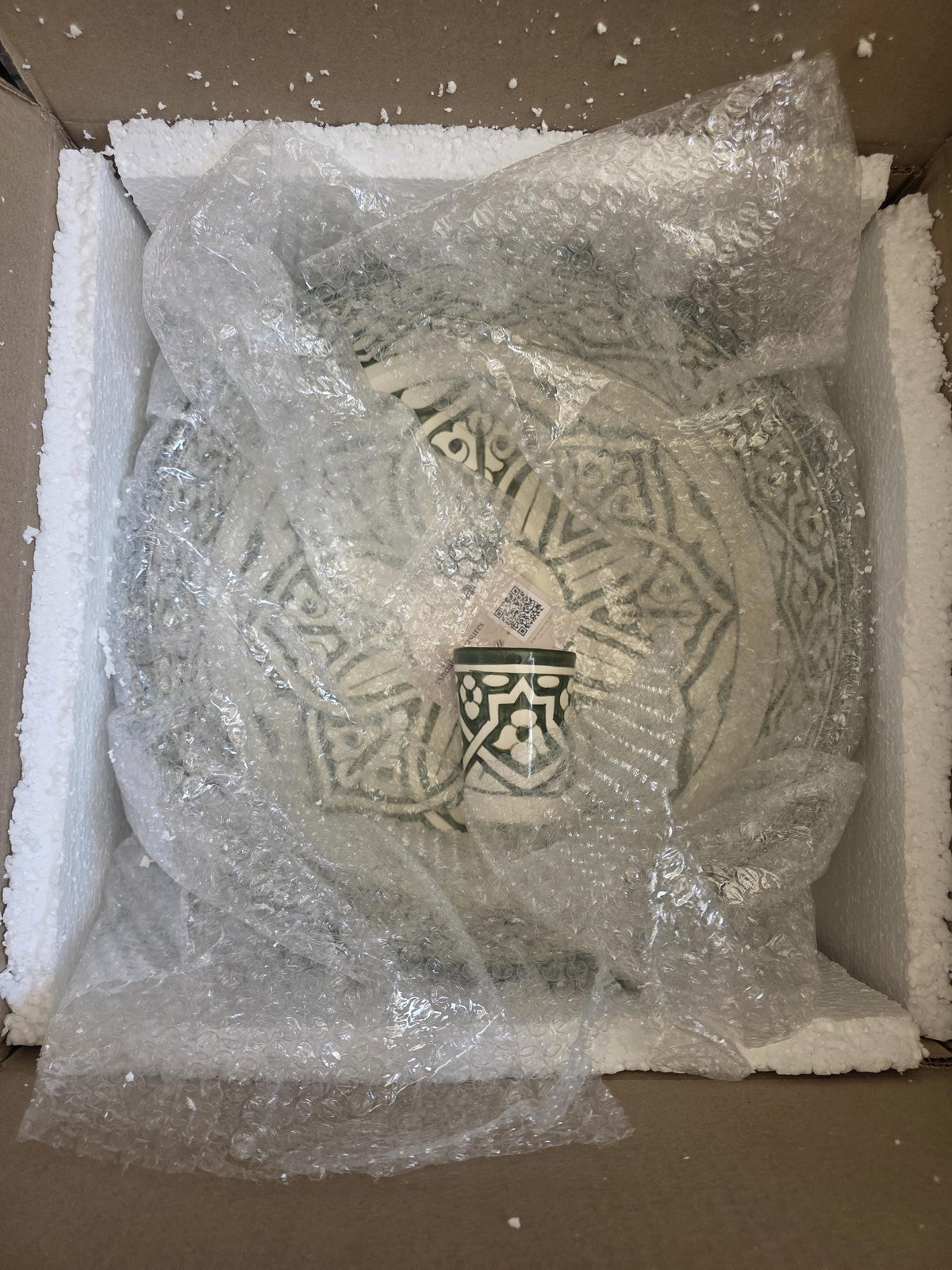 packaging of handmade ceramic sink with free cup included in the package with same design and color