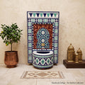 a decorative Arabic-style fountain with a mosaic design, surrounded by a potted plant, a small tree, and a wooden stand with brass lanterns.