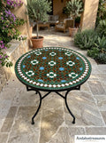 May include: Round mosaic tile table with a black metal frame. The tabletop features a geometric pattern in shades of green, brown, white, and blue. The table is outdoors, surrounded by plants and stone flooring.
May include: A set of three ceramic nesting bowls in shades of blue, green, and white. The bowls feature a speckled glaze and a simple, modern design. The largest bowl measures approximately 6 inches in diameter.