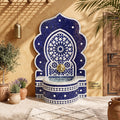 a decorative blue and white mosaic fountain with a golden lion statue, situated in a room with a wooden door and potted plants.