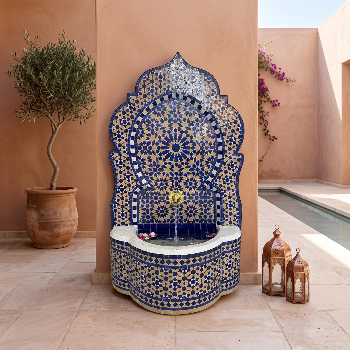 a decorative fountain with a blue and gold mosaic design, situated in a courtyard with a pool and potted plants.