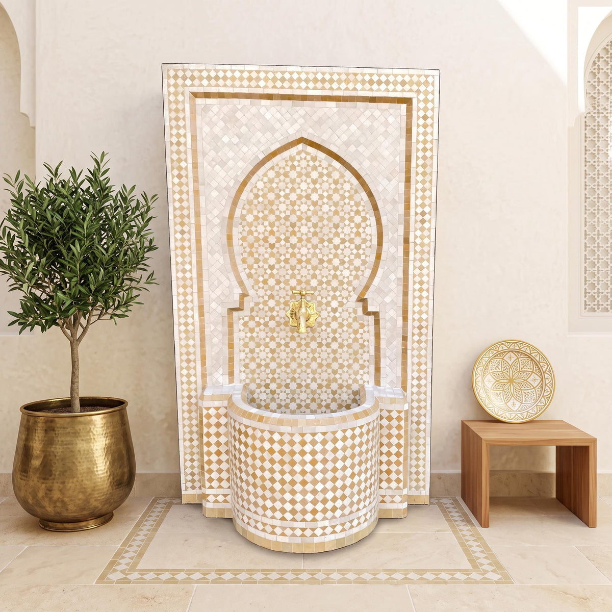 a luxurious bathroom with a large, ornate fountain adorned with gold and white tiles. The fountain is surrounded by a wooden table and a potted plant, creating a serene and elegant atmosphere.