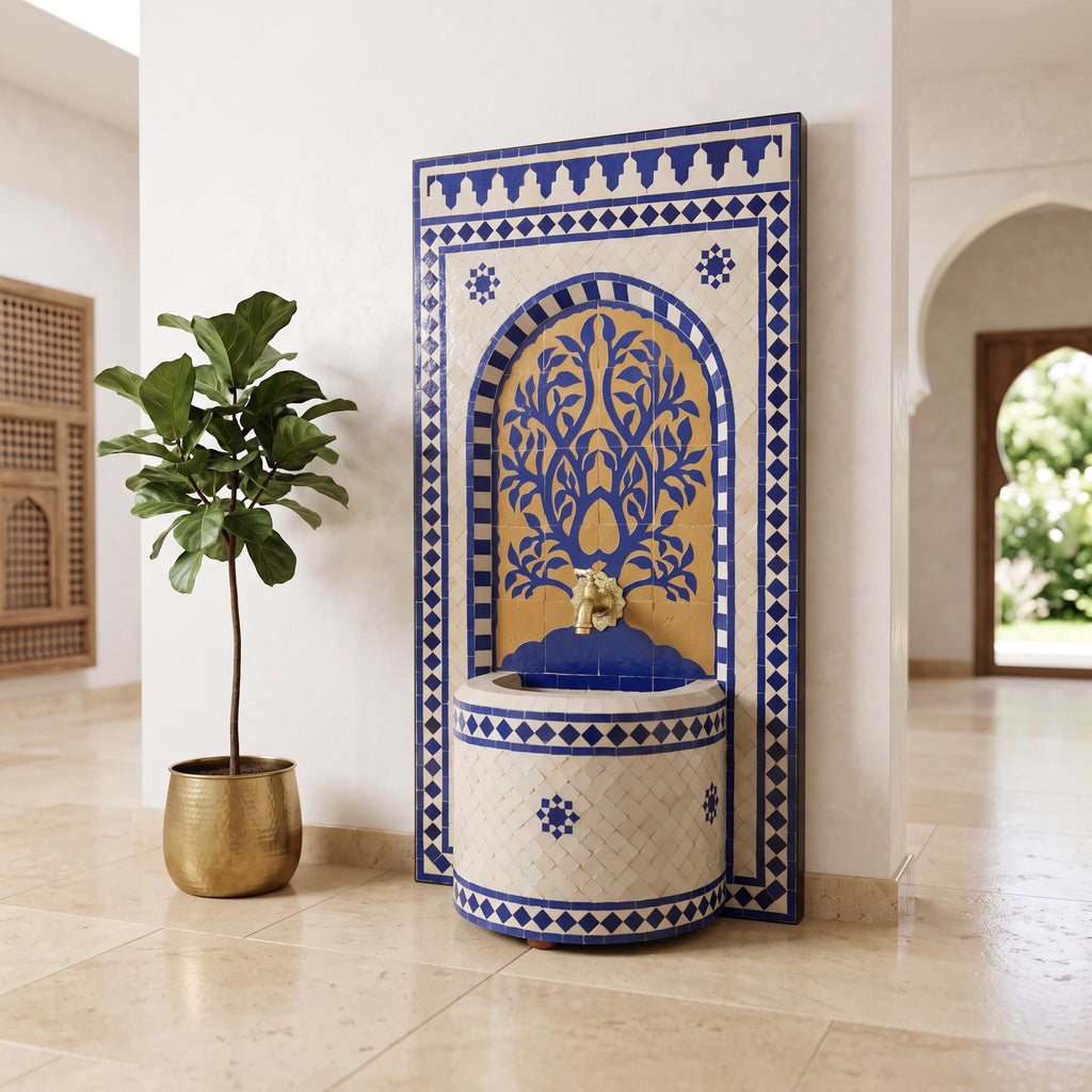 a decorative blue and white tile fountain with a gold-colored base, situated in a room with a potted plant and a wooden archway visible.