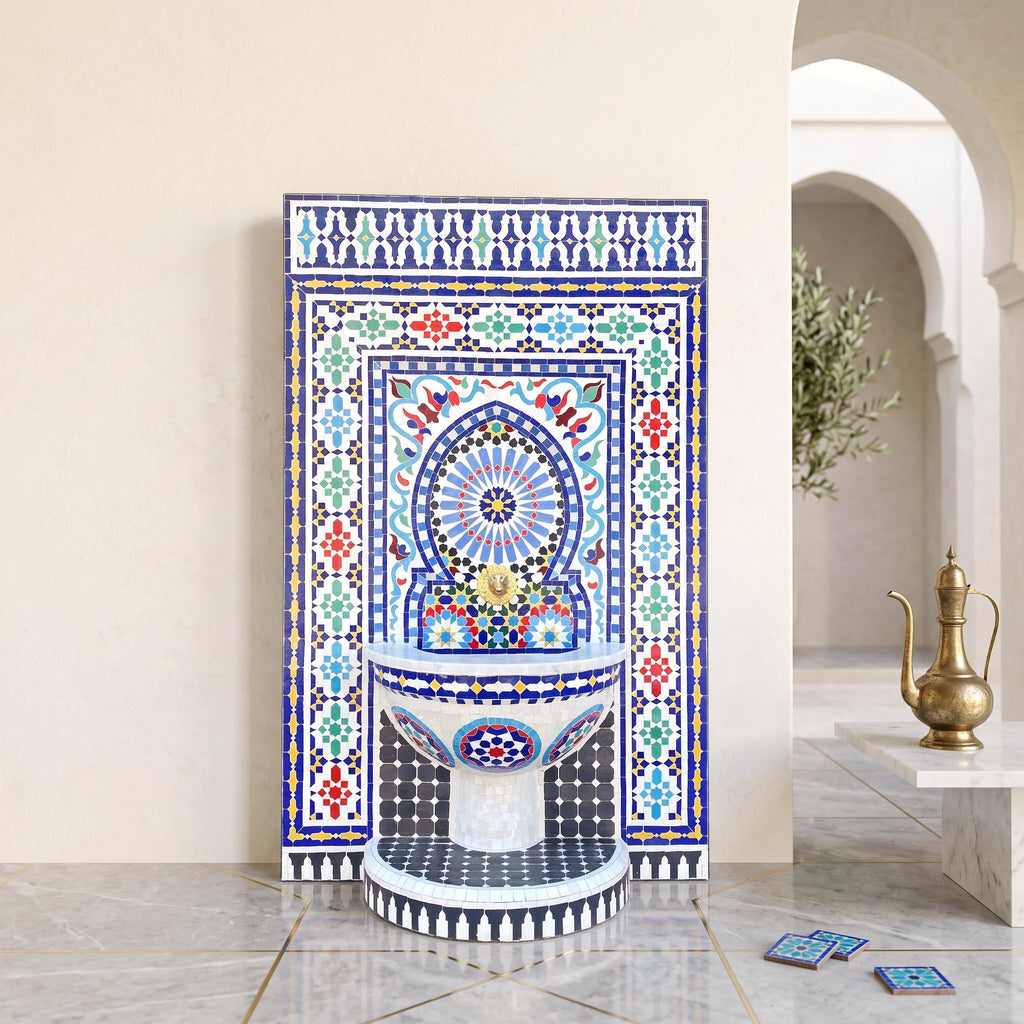 a colorful mosaic fountain with intricate patterns and designs, situated in an arched hallway with a white archway and a potted plant nearby.