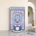 a colorful mosaic fountain with intricate patterns and designs, situated in an arched hallway with a white archway and a potted plant nearby.