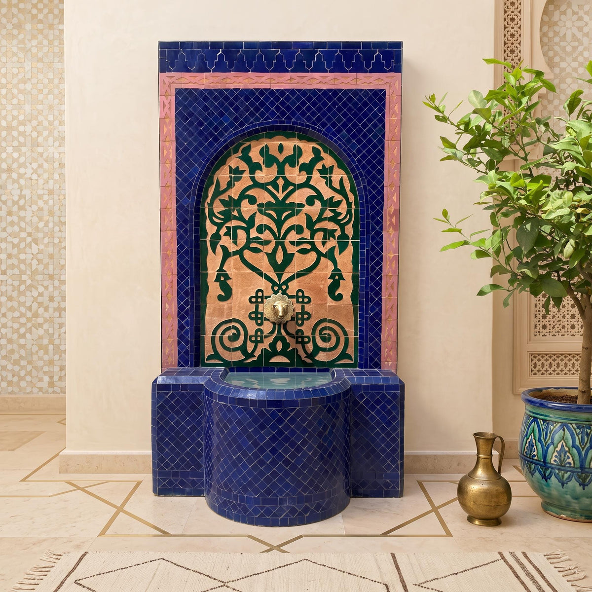 a blue and gold mosaic fountain with a decorative arch, situated in a room with a tiled floor and a potted plant.