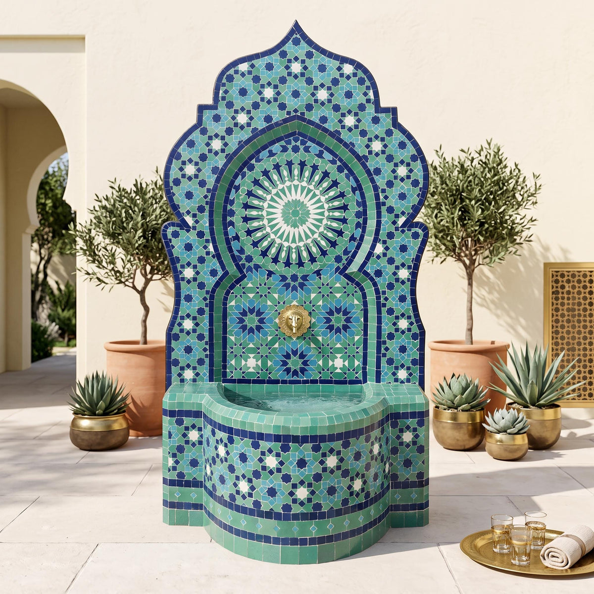 a decorative fountain with a blue and white tile design, surrounded by potted plants and a tray of glasses.