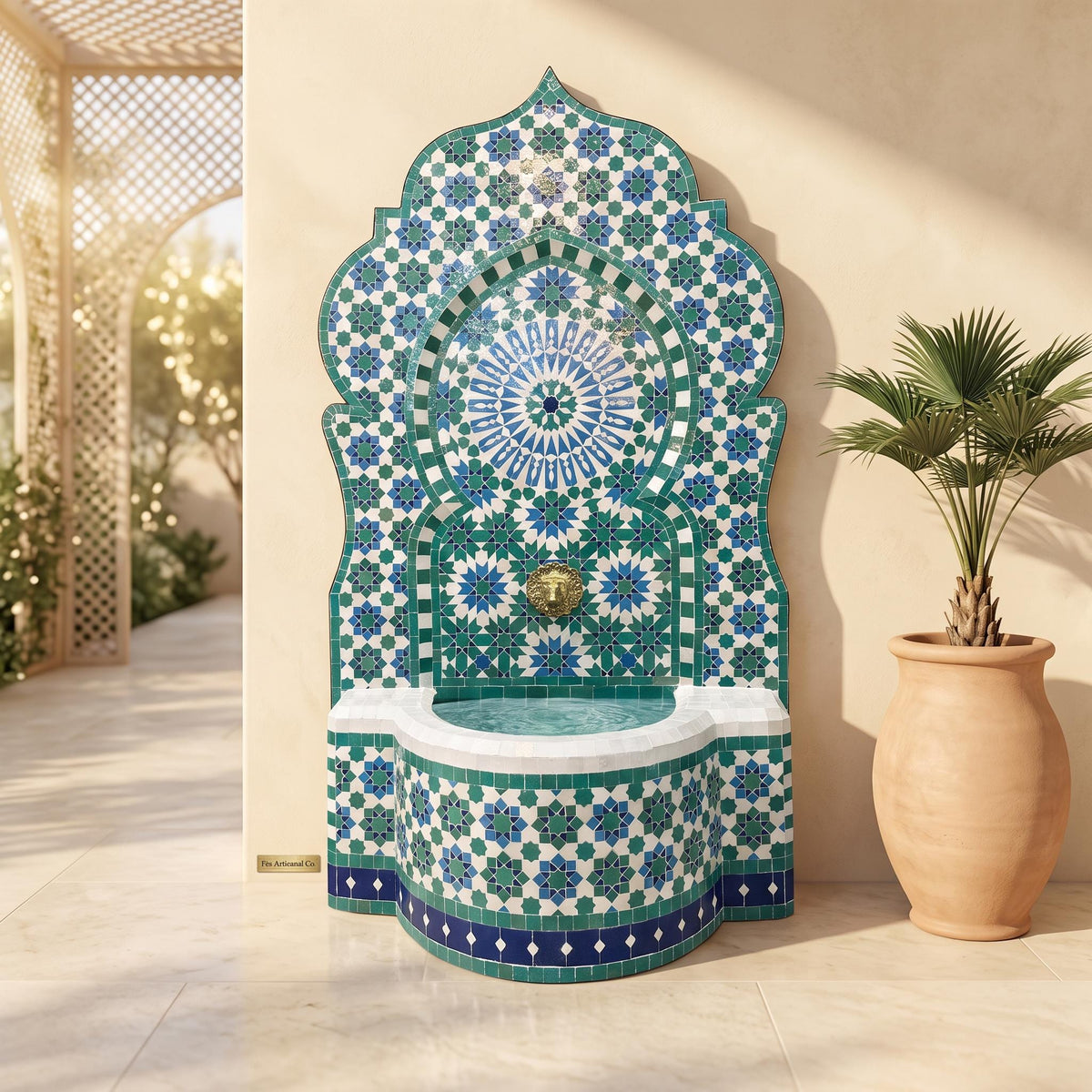 a decorative fountain with a mosaic design in shades of blue and green, situated in a courtyard. Next to the fountain is a potted plant, and the background includes a lattice structure and a wall.
