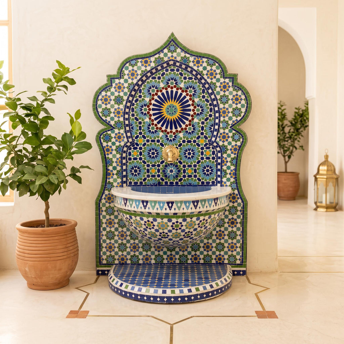 a decorative mosaic fountain with a blue and white pattern, situated in a room with a potted plant and a lantern.
