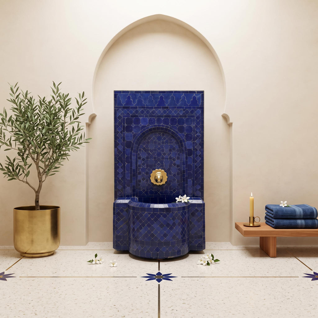 a luxurious bathroom with a blue mosaic tile fountain, a potted plant, and a wooden bench. The room has a neutral color scheme with white walls and a tiled floor.