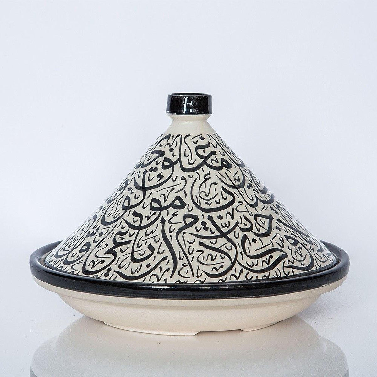 A ceramic cooking pot with a black and white pattern, featuring Arabic script, is displayed against a white background.